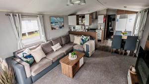 a living room with a couch and a table at The Ocean Nook in New Quay