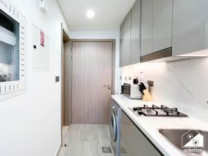 Una cocina blanca con fregadero y estufa. en Modern Comfort Studio Relax & Unwind in Style, en Dubái