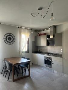 a kitchen with a wooden table and a dining room at La Graziosa in Arezzo