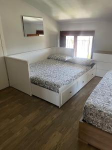 a bedroom with two beds and a mirror on the wall at La Graziosa in Arezzo