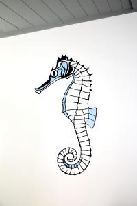 a drawing of a seahorse on a wall at Casa da Baía - Guest House in Horta