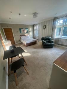 a large bedroom with a bed and a couch at 3 x Studios Golden Manor in Hanwell +11 photos
