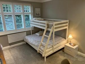 a bedroom with two bunk beds with a ladder at 3 x Studios Golden Manor in Hanwell
