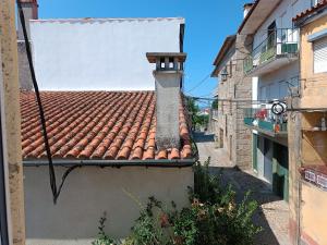 a tile roof of a building with a sign on it at Casa 2 Andrades in Belmonte