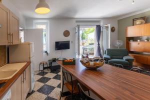 a kitchen with a table with a bowl of fruit on it at Micocoulier de la Maréchale in Orgnac-lʼAven