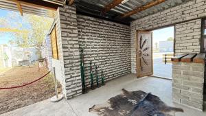 a room with a brick wall and a door at Marzel Guesthouse - Room 2 in Britstown