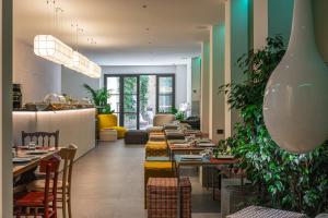a restaurant with tables and chairs and plants at Arco Vecchio Urban Suite - Epoca Collection in Lecce