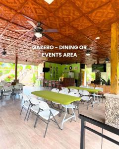 a restaurant with tables and chairs and a ceiling at Lovenista Retreat and Camping Site - Exclusive Stay near Canyoneering in Alegria