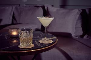 a table with a martini and two glasses on it at Sant Francesc Hotel Singular in Palma de Mallorca
