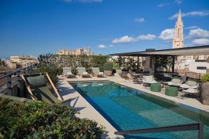 a swimming pool on the roof of a building at Sant Francesc Hotel Singular in Palma de Mallorca