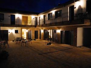 a courtyard of a building with tables and chairs at night at M43 - Ubytování v soukromí in Sedlec