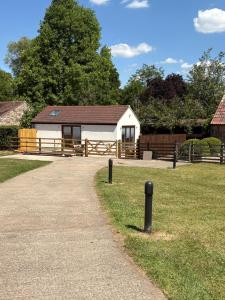 a white building with a brown roof in a field at Portbridge Nest in Chew Magna