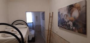 a bedroom with a bed and a painting on the wall at Casa BLU in Torre Squillace