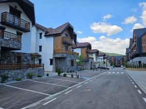 an empty parking lot in front of some buildings at Daan dream apart in Kolašin