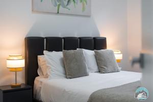 CobbittyAircabin - Cobbitty Spacious 4BR with 2 Baths的卧室里有一张床，床单和枕头都是白色的