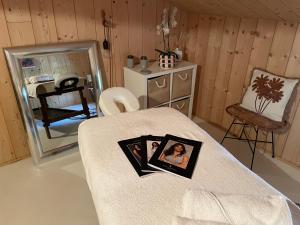 a room with a bed with a picture on it at Les ptis chiffons in Lacanau