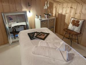 a room with a bed with a picture on it at Les ptis chiffons in Lacanau
