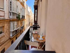 a balcony with a table and chairs on a balcony at inncadiz El Refugio de Gadir in Cádiz