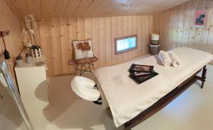 a room with a bed and a chair in it at Les ptis chiffons in Lacanau