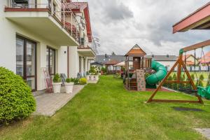 a yard with a playground in a house at Villa Laguna in Rowy