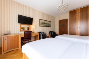 Postel nebo postele na pokoji v ubytování Hotel Majestic