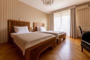 Postel nebo postele na pokoji v ubytování Hotel Majestic