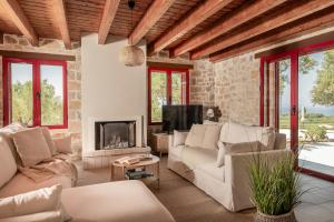 a living room with a couch and a fireplace at Geracasa Stone Villa in Méson Yerakaríon