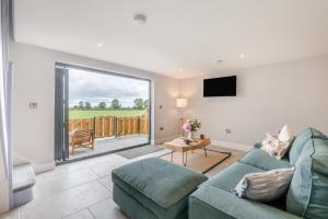 a living room with a couch and a tv at 1 Bed in Marishes oc-l32534 in Kirby Misperton