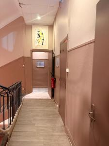a hallway with a hallway leading to a door at HOTEL SYLVABELLE in Marseille