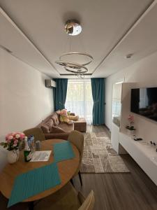 a living room with a couch and a table at Sea Home 9 in Sunny Beach