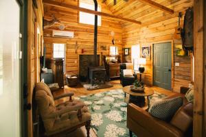 a living room filled with furniture and a fireplace at Riverstone Cottage A Cozy Riverfront Retreat in Dahlonega