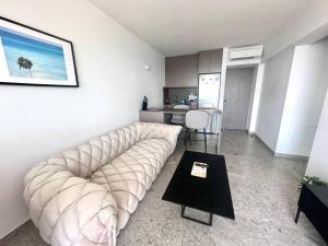 a living room with a large couch and a table at Star in Bat Yam