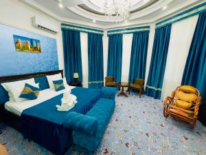 a hotel room with a bed and a chair at Garden Boutique Hotel in Bukhara