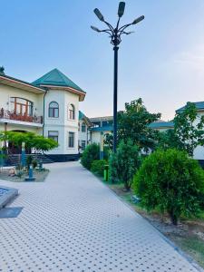a building with a street light in front of it at Garden Boutique Hotel in Bukhara