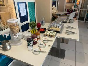 a table with food on it in a kitchen at Les Alcyons in Le Lavandou
