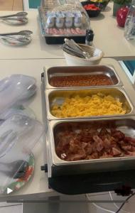 a counter with two trays of food on a table at Les Alcyons in Le Lavandou