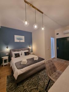 a bedroom with a large bed and a chair at SOLARIS Villa in Ocna Sibiului