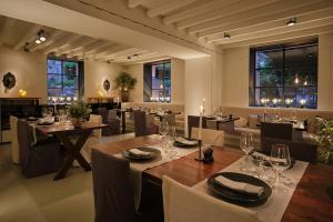 a dining room with tables and chairs and windows at Sant Francesc Hotel Singular in Palma de Mallorca