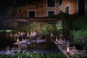 a table set up for a meal in a garden at night at Sant Francesc Hotel Singular in Palma de Mallorca