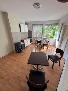 a kitchen and dining room with a table and chairs at Vastus homes in Duisburg