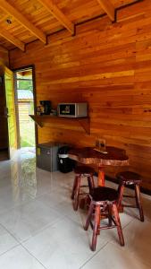 a room with a table and two chairs and a microwave at Entre Árboles Lodge in San Gerardo de Dota +144 photos