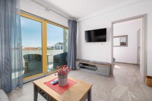 Televízia a/alebo spoločenská miestnosť v ubytovaní Apartment Markič