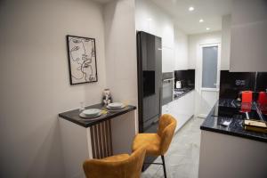 a kitchen with a small table and two chairs in it at Kastrino Luxury Studio in Ioannina