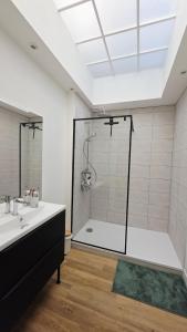 a bathroom with a shower and a tub and a sink at l'Eclat Malouin - Parking & Garden in Dunkerque