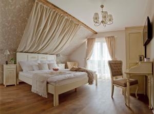 a bedroom with a bed and a chair and a piano at Barackvirág Apartmanház in Tihany +60 photos
