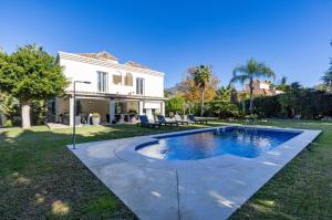 a house with a swimming pool in the yard at Stunning 5 Bedroom Villa in Puerto Banus with Pool in Marbella