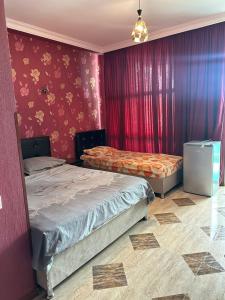 two beds in a room with red walls at Hotel Lile in Ureki