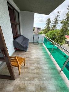 a balcony with a view of a swimming pool at Hotel Lile in Ureki +7 photos