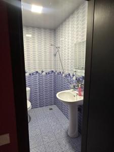 a bathroom with a sink and a toilet at Hotel Lile in Ureki