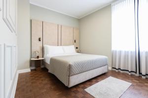 Postel nebo postele na pokoji v ubytování Hotel Majestic